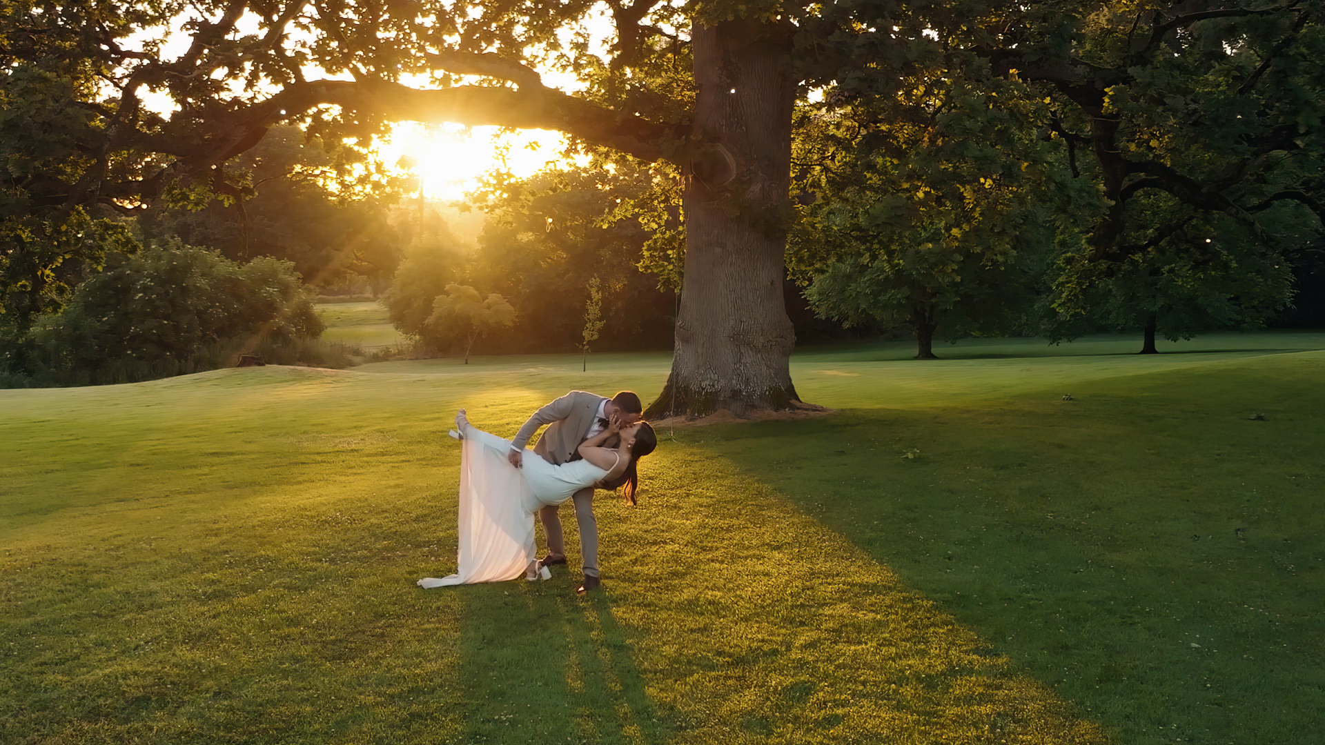 A couple share a sunset kiss on their wedding at Rathsallagh co. Wicklow