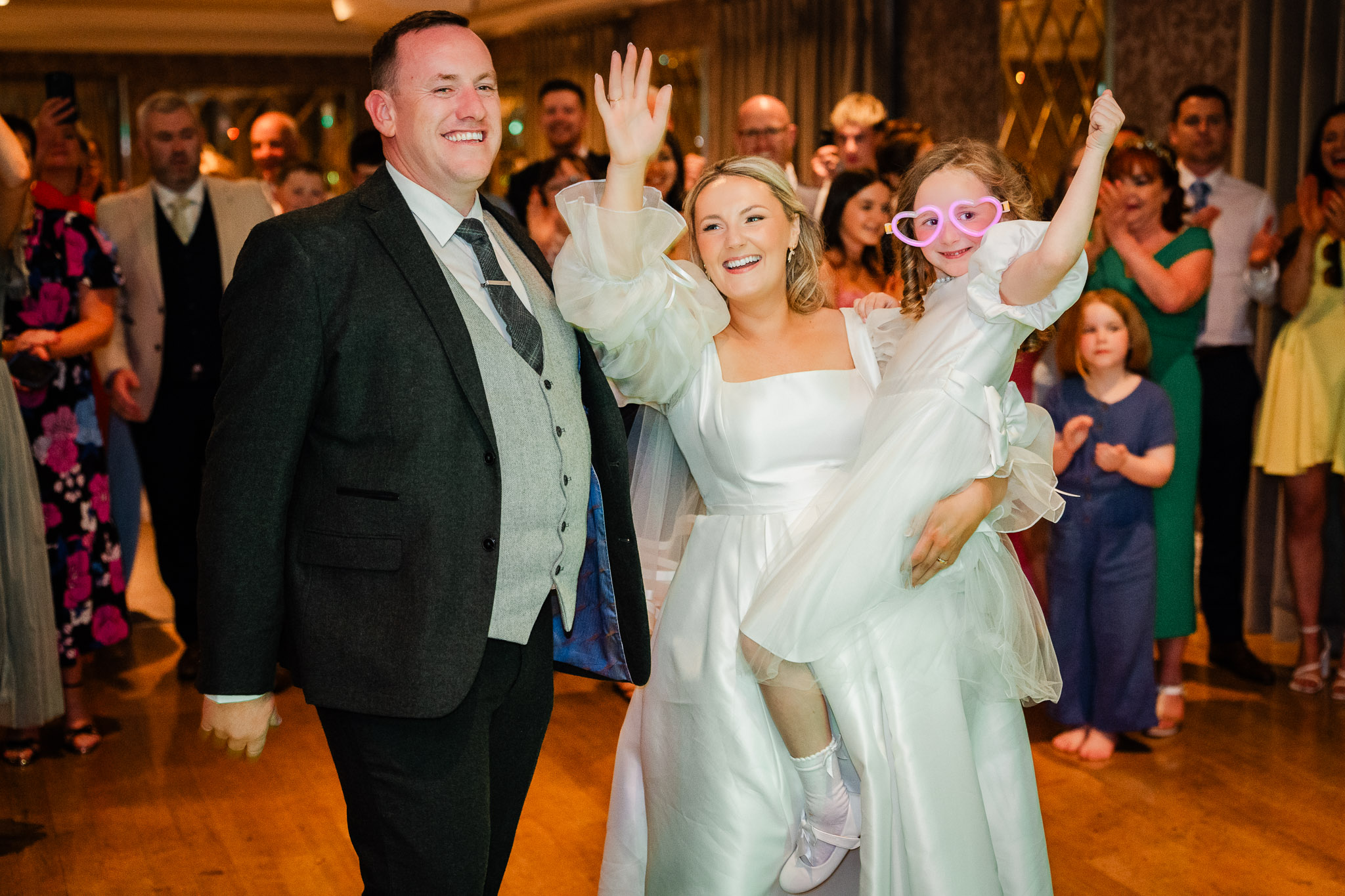Bride and groom engoy a dance with their daughter on their wedding day at An Chuirt Hotel Gweedore Co. Donegal